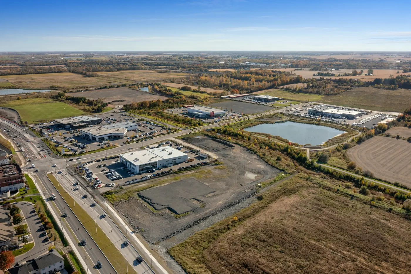 Aerial view of a commercial development site beside a highway